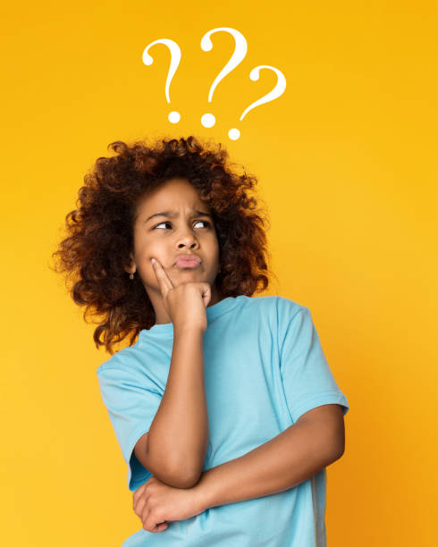 istock Child girl having questions over yellow background 1140094561