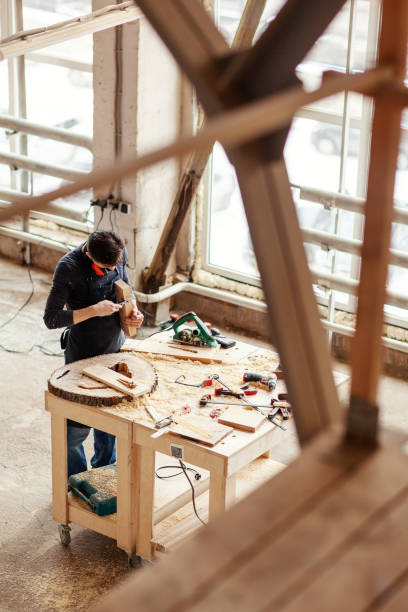 istock From above young woodworker measuring wooden plank with vernier caliper tool at workbench 1140094748