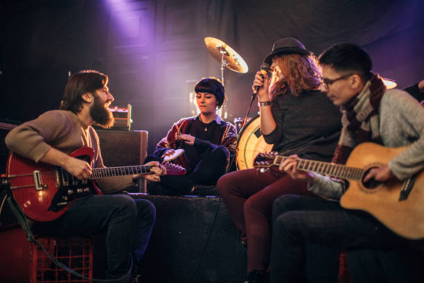 istock Modern music band performing on stage in nightclub 1140096239