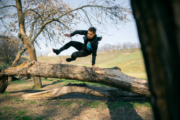 istock Man running in a park or forest against trees background. 1140096898