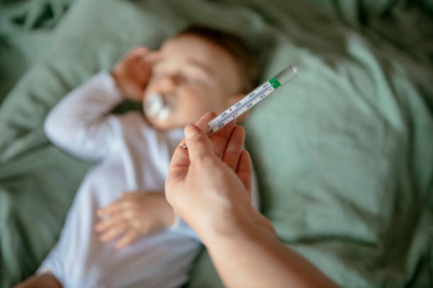 sick baby with high fever - child fever illness thermometer imagens e fotografias de stock