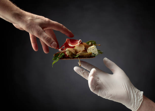 istock Rye cracker with blue cheese, prosciutto and pear garnished with capers and cornichon. 1140098153
