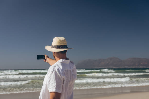 istock Man talking selfie standing at beach 1140099927
