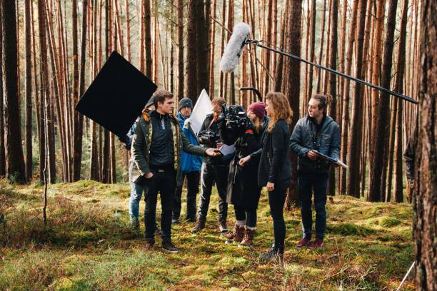 Behind the scene. Film crew team filming movie scene on outdoor location. Group cinema set. 8.9.2017 Nuremberg, Germany: Behind the scene. Film crew team filming movie scene on outdoor location. Group cinema set. film crew photos stock pictures, royalty-free photos & images