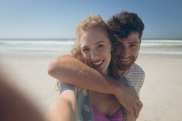 istock Happy couple standing at beach 1140101981