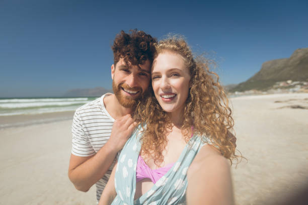 istock Caucasian couple standing at beach 1140101995