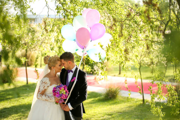 istock Beautiful wedding couple posing outdoor with balloons 1140102811