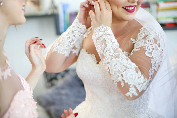 istock Bride posing indoor and try to fix her earrings 1140103046