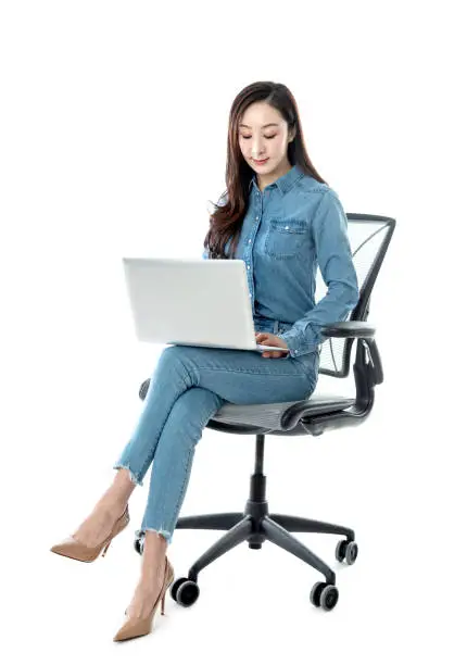 Photo of Woman sitting on office chair and using laptop