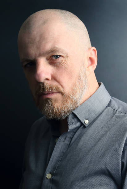 istock portrait of a bearded man on a dark background 1140103432