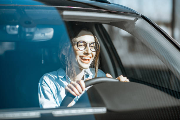 istock Happy woman driving a car 1140104051