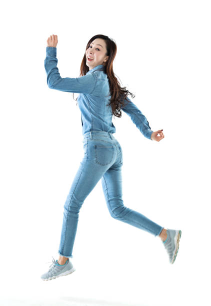 istock Excited woman jumping on white background 1140104065