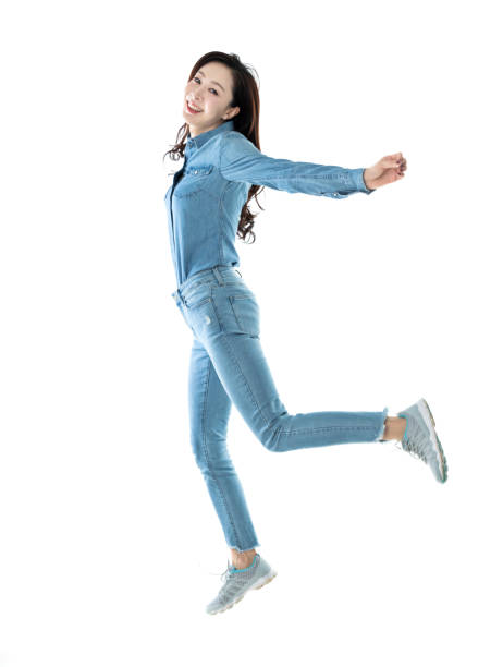 istock Excited woman jumping on white background 1140104142