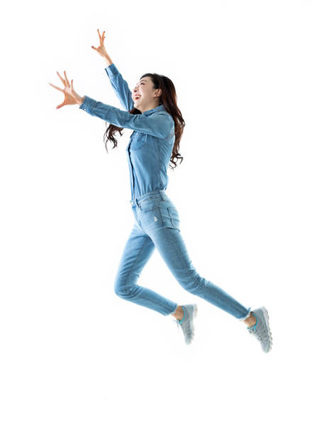 istock Excited woman jumping on white background 1140104339