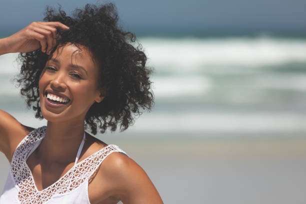 istock Beautiful woman giving pose while standing at beach 1140104493