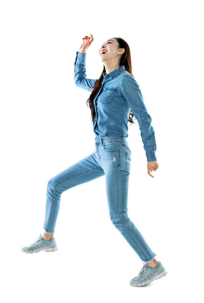 istock Excited woman jumping on white background 1140104621