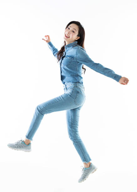 istock Excited woman jumping on white background 1140104658