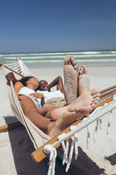 istock Happy couple relaxing on hammock at beach 1140106063