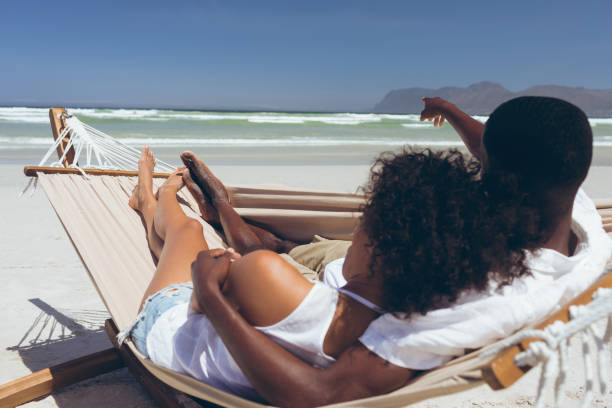 istock Young couple relaxing on hammock at beach 1140106071