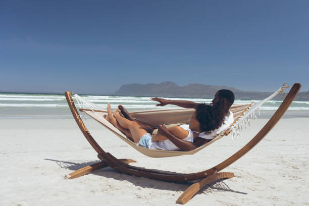 istock Couple relaxing on hammock at beach 1140106088