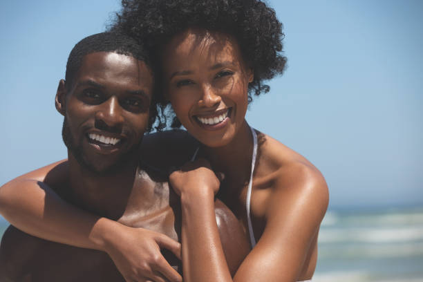 istock Happy couple standing at beach 1140106805