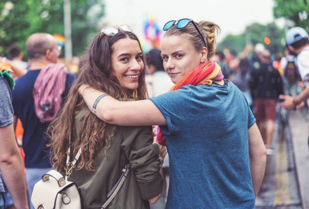 istock Young female couple walking with the pride parade 1140107687