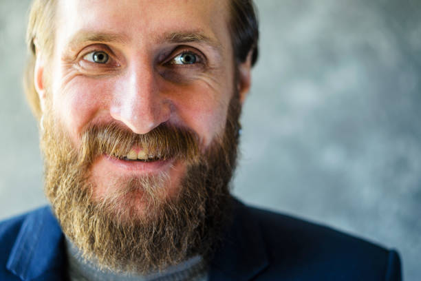istock Man with a Beard is Talking and Laughing Close Up 1140108840