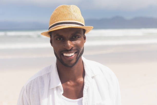 istock Man standing at beach on a sunny day 1140111636