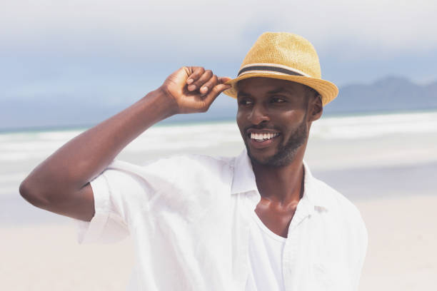 istock Man standing at beach on a sunny day 1140111674