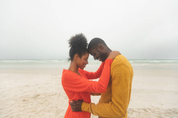 istock Couple standing at beach on a sunny day 1140113546