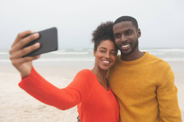 istock Romantic couple taking selfie at beach on a sunny day 1140113560