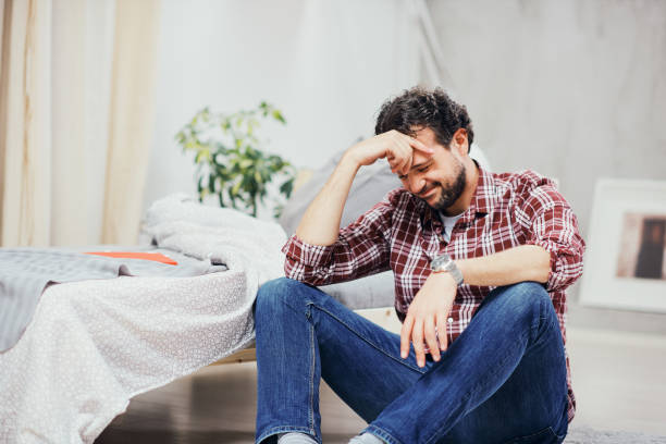 istock Man sitting on the floor and having depression. 1140113821