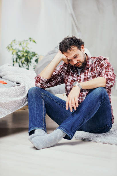 istock Man sitting on the floor and having depression. 1140113903