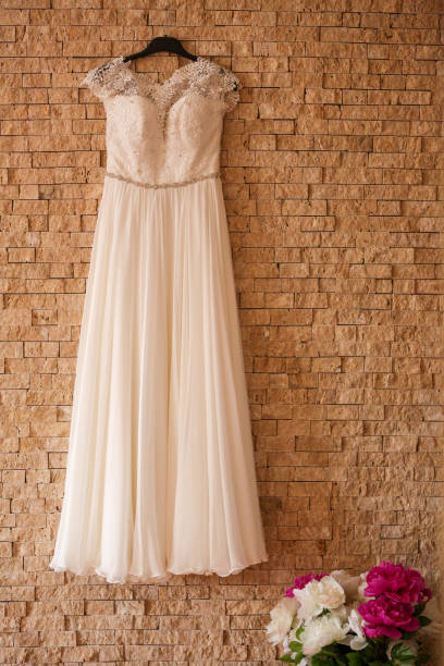 istock Wedding dress hanged on wall 1140117531