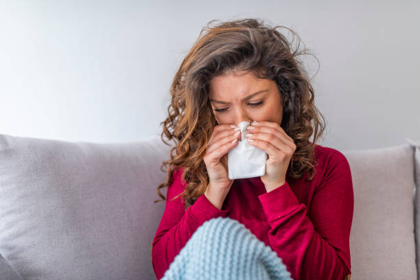 istock Sick woman with headache sitting under the blanket. 1140118050