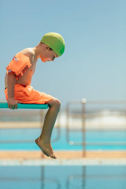 istock Boy afraid of diving in the pool 1140119870