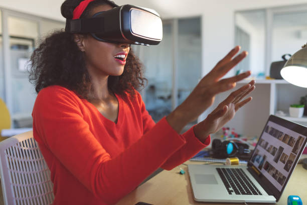 istock Female graphic designer using virtual reality headset at desk 1140120580