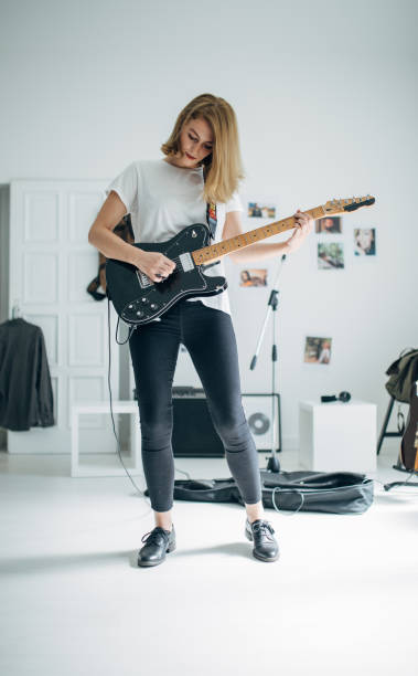 istock Beautiful lady playing electric guitar 1140120610