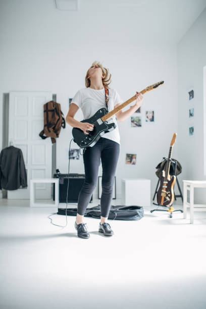 istock Beautiful woman playing electric guitar 1140120630