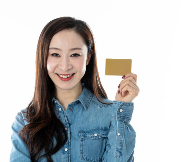 istock Woman holding credit card on white background 1140120664