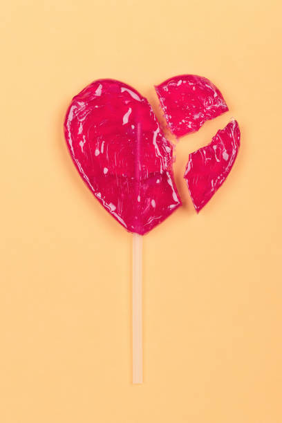 istock Broken lollipop candy heart love shape 1140122007