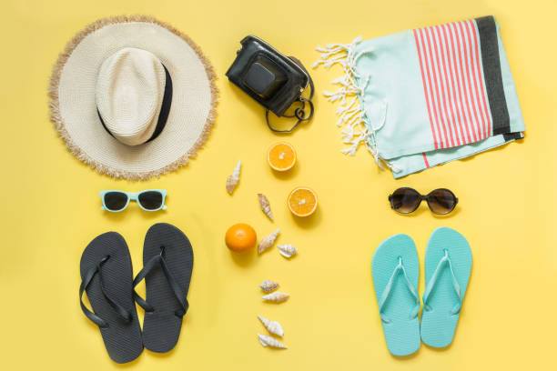 Beach accessories for two, straw beach sunhat,towel, sun glasses on yellow. Summer concept and tropical vacations. Beach accessories for two, straw beach sunhat,towel, sun glasses on yellow with space for text. Summer concept. sarong stock pictures, royalty-free photos & images