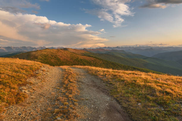 istock road dirt mountain clouds top 1140122599