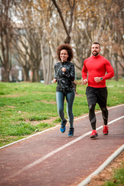 istock Two young active athletes jogging together on a running track in a public park 1140123210