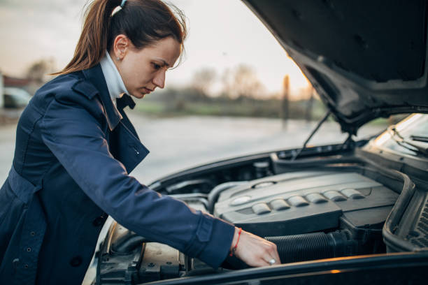 istock Woman is trying to fix her car 1140123573