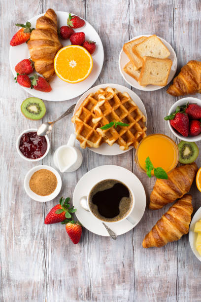 istock Continental breakfast table with coffee, orange juice, croissants 1140123891