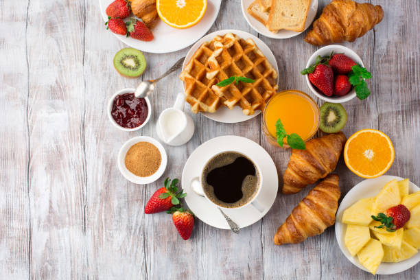 istock Continental breakfast table with coffee, orange juice, croissants 1140123896