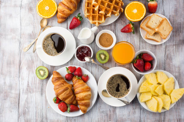 istock Continental breakfast table with coffee, orange juice, croissants 1140123907