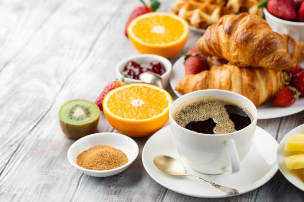 istock Continental breakfast table with coffee, orange juice, croissants 1140123922