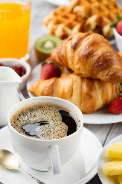istock Continental breakfast table with coffee, orange juice, croissants 1140123940